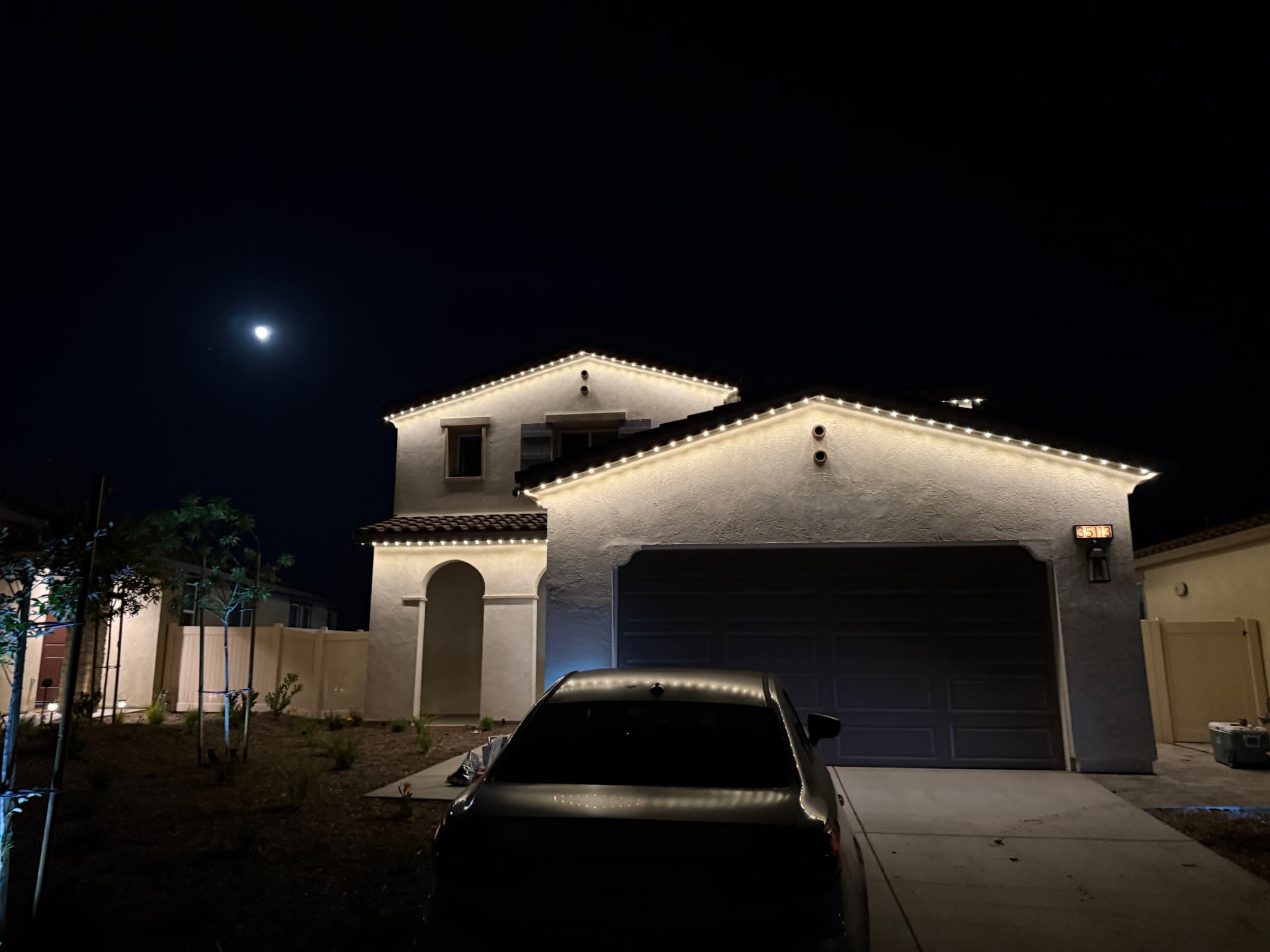 Warm white lighting outlining a two-story home
